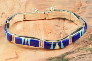 Genuine Blue Lapis and Turquoise inlaid in Sterling Silver. Beautiful Fire and Ice Lab Opal Accents. Stunning bracelet Designed by Navajo Artist Calvin Begay. Signed.